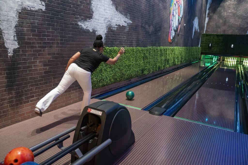 Employee bowling at event