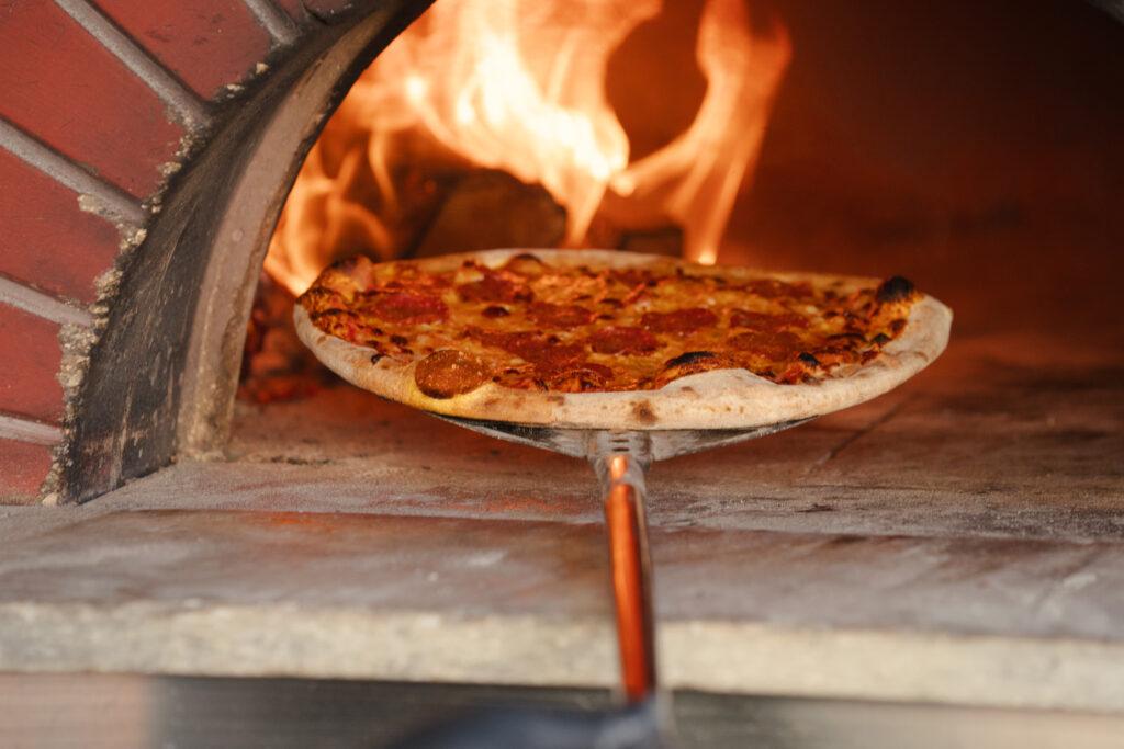 Pepperoni pizza in wood-fired oven